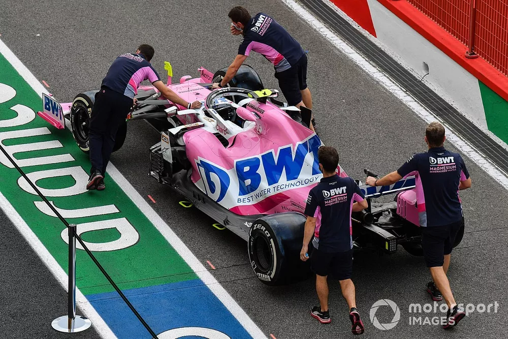 Racing point mechanics push Lance Stroll's Racing Point RP20 along the pitlane