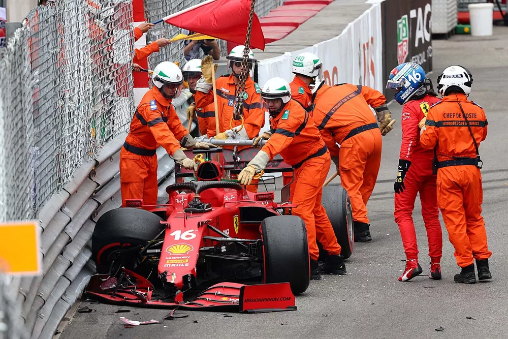 Marshals assist Charles Leclerc, Ferrari SF21, after he crashes out of Qualifying