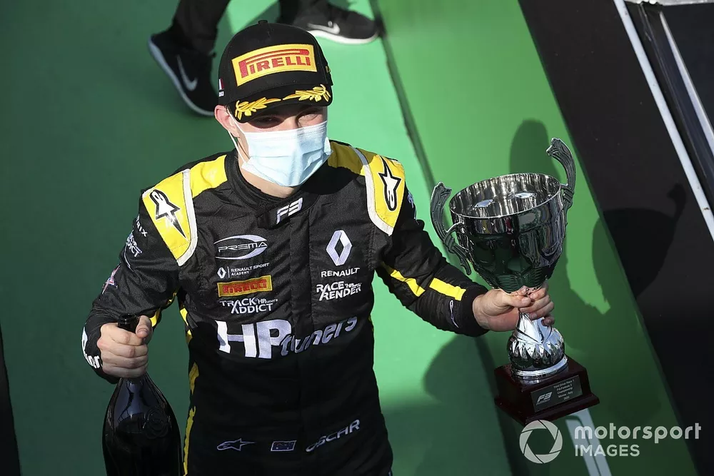 Oscar Piastri, Prema Racing celebrates on the podium with the champagne and the trophy