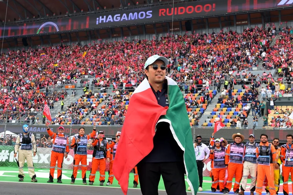 Sergio Perez, Red Bull Racing, holds up the Mexican flag