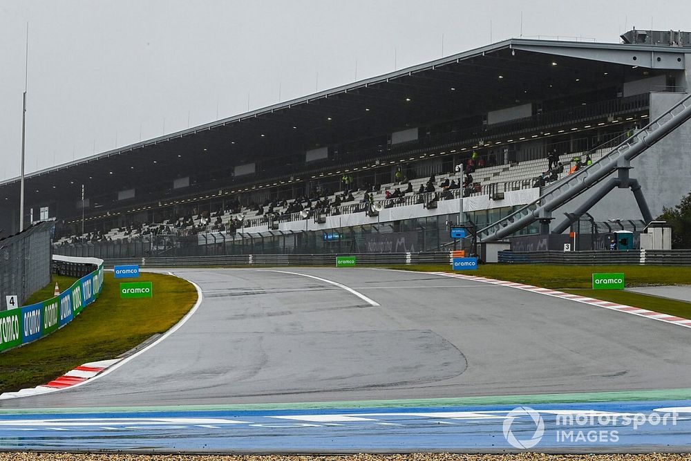Fans wait out in the delay in the grandstand