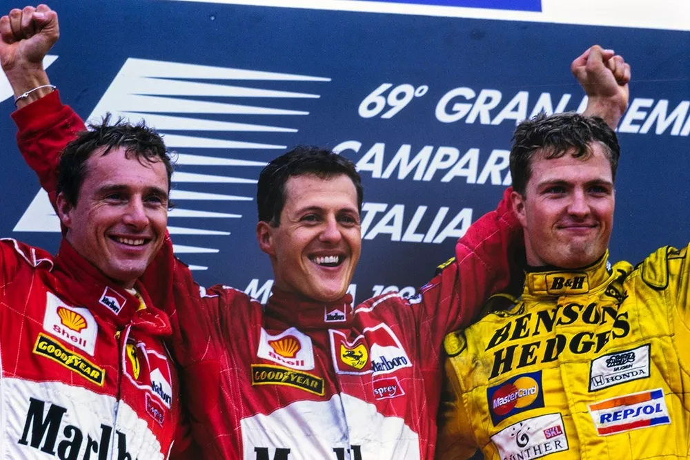 Eddie Irvine, 2nd position, Michael Schumacher, 1st position, and Ralf Schumacher, 3rd position