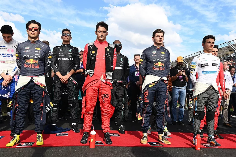 The drivers stand on the grid for the national anthem