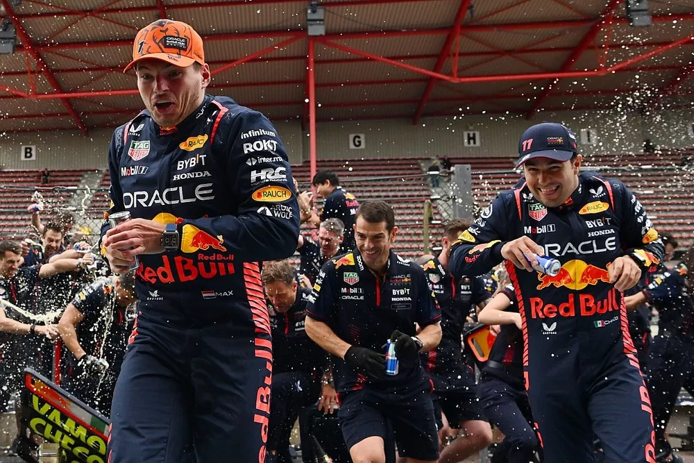 Max Verstappen, Sergio Perez celebrate with Red Bull Racing team members