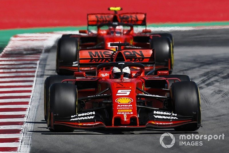 Sebastian Vettel, Ferrari SF90, leads Charles Leclerc, Ferrari SF90