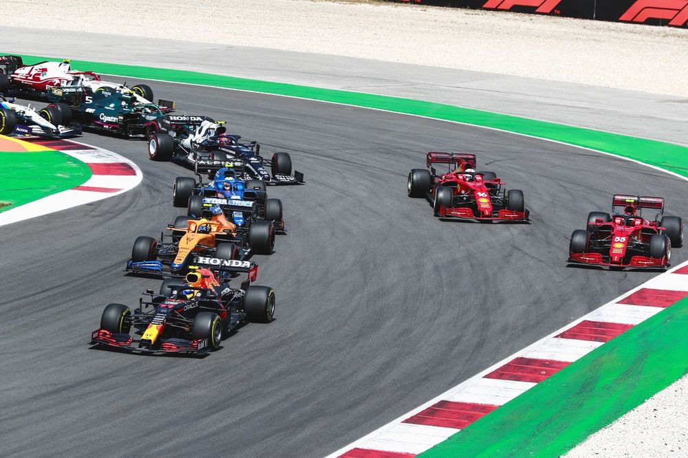 Sergio Perez, Red Bull Racing RB16B, Lando Norris, McLaren MCL35M, Esteban Ocon, Alpine A521, Carlos Sainz Jr., Ferrari SF21, Charles Leclerc, Ferrari SF21, and Pierre Gasly, AlphaTauri AT02, at the restart