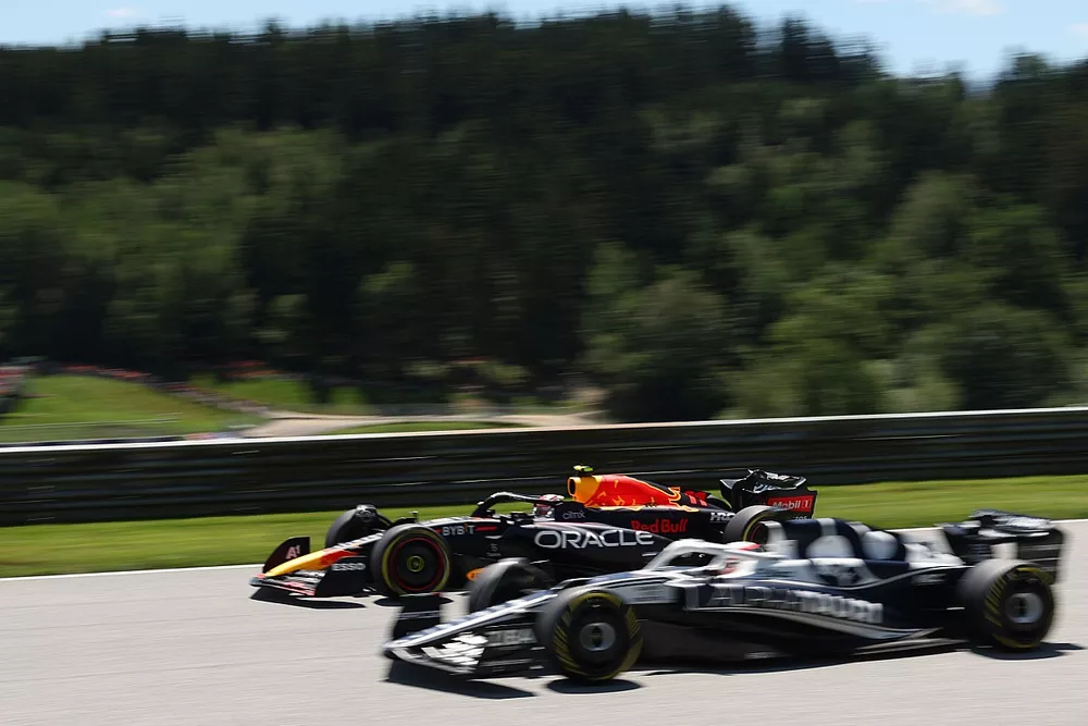 Sergio Perez, Red Bull Racing RB18, alongside Pierre Gasly, AlphaTauri AT03