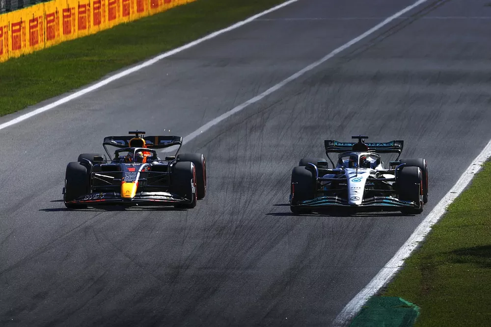 Max Verstappen, Red Bull Racing RB18, passes George Russell, Mercedes W13