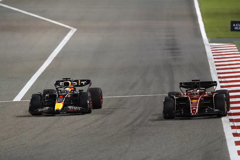 Max Verstappen, Red Bull Racing RB18, battles with Charles Leclerc, Ferrari F1-75