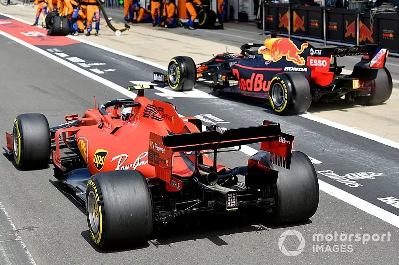 Max Verstappen, Red Bull Racing RB15, and Charles Leclerc, Ferrari SF90, race to be first out of the pit lane