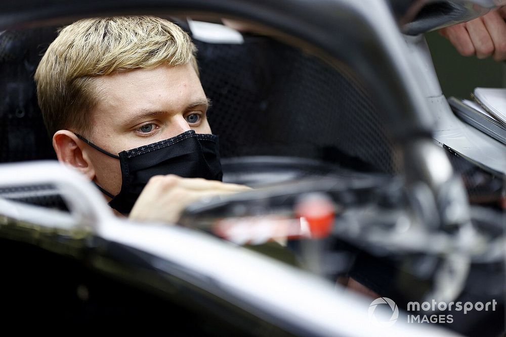 Mick Schumacher sits in his Haas VF-20 for his seat fitting.  