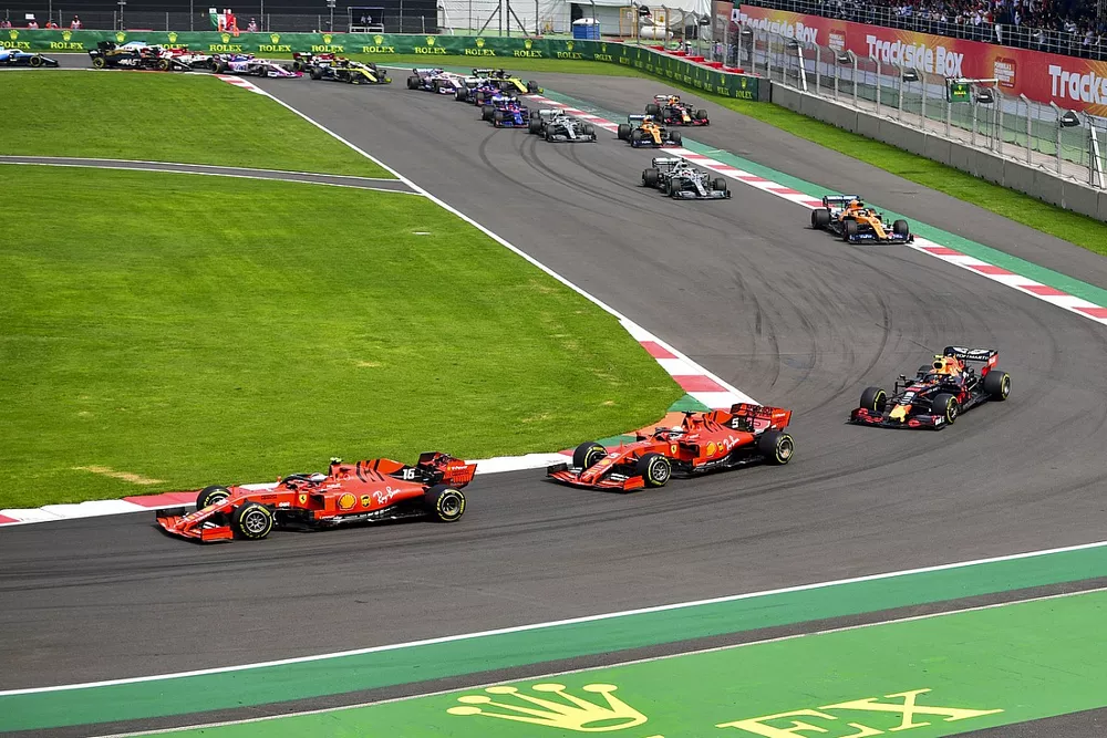 Charles Leclerc, Ferrari SF90, leads Sebastian Vettel, Ferrari SF90, Alex Albon, Red Bull RB15, Carlos Sainz Jr., McLaren MCL34, Lewis Hamilton, Mercedes AMG F1 W10, and the rest of the field on the opening lap