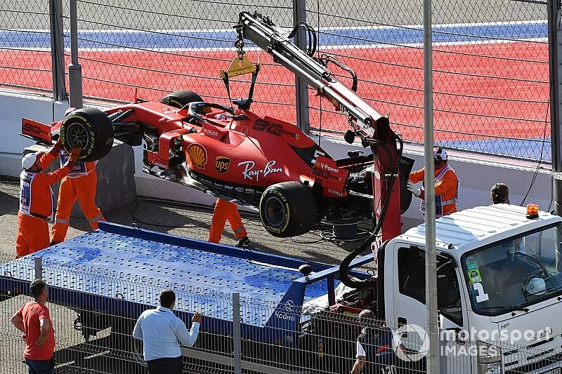 Marshals load the car of Sebastian Vettel, Ferrari SF90, onto a truck