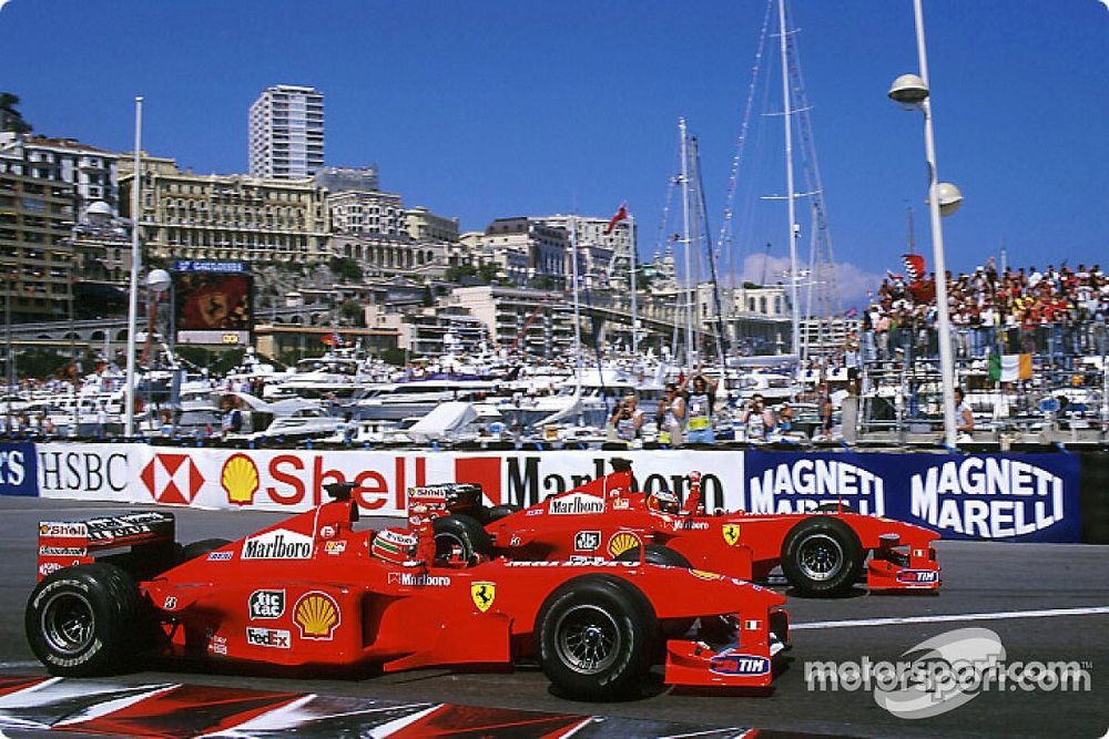 Race winner Michael Schumacher celebrates with second place Eddie Irvine