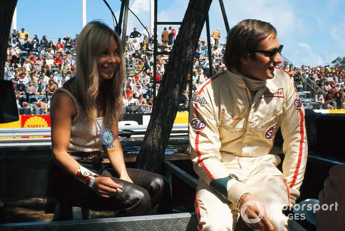Chris Amon se sienta con su novia en el muro de boxes