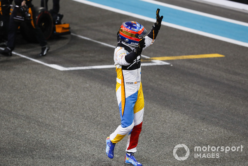 Fernando Alonso, McLaren, waves to the fans after completing his final race in F1