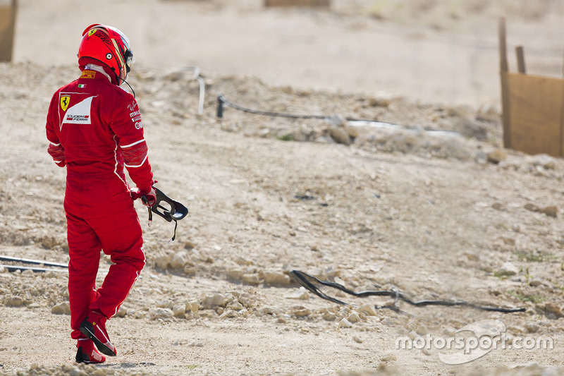 Kimi Raikkonen, Ferrari, walks back to his garage