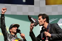 (L to R): Daniel Ricciardo, Red Bull Racing celebrates his second position on the podium with Mark Webber, Porsche Team WEC Driver / Channel 4 Presenter, who drinks champagne from Daniel's race boot