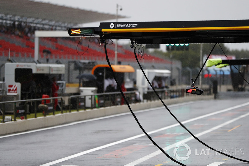 Rain falls in the pit lane