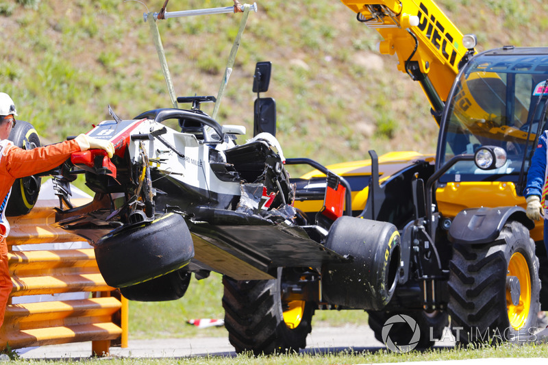 The damaged Romain Grosjean Haas F1 Team VF-18 is removed from the circuit by marshals