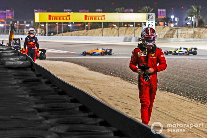 Charles Leclerc, Ferrari, se aleja después de retirarse y detrás Max Verstappen, de Red Bull Racing