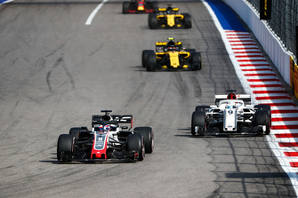 Romain Grosjean, Haas F1 Team VF-18, leads Marcus Ericsson, Sauber C37, and Carlos Sainz Jr., Renault Sport F1 Team R.S. 18