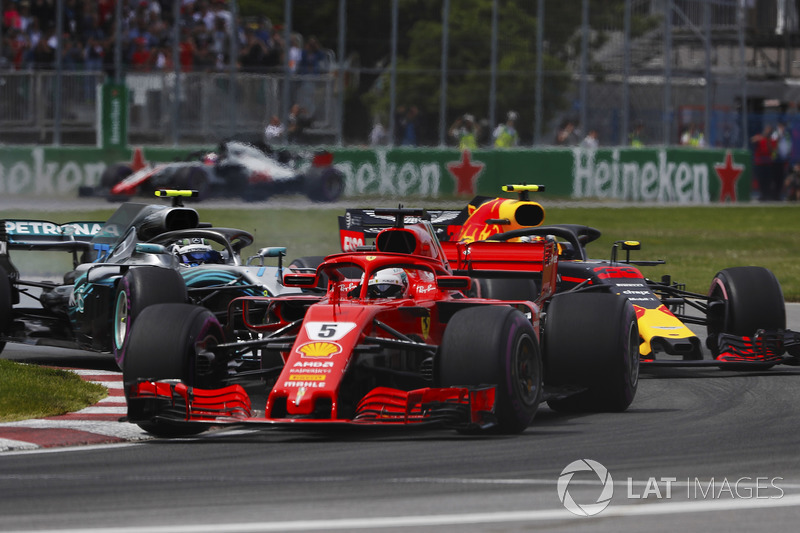 Sebastian Vettel, Ferrari SF71H, leads Valtteri Bottas, Mercedes AMG F1 W09 and Max Verstappen, Red