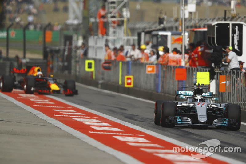 Valtteri Bottas, Mercedes AMG F1 W08, leads Daniel Ricciardo, Red Bull Racing RB13, out of the pit l