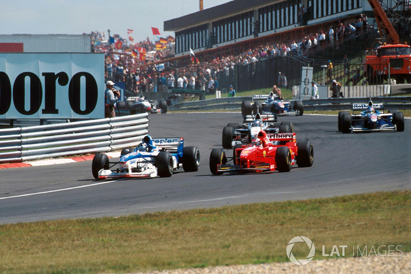 Damon Hill. Arrows A18 overtakes Michael Schumacher, Ferrari F310B