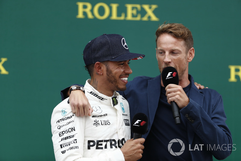 Race winner Lewis Hamilton, Mercedes AMG F1, is interviewed by Jenson Button, McLaren, on the podium