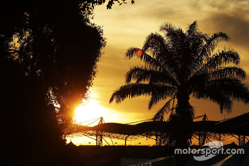 the sun sets over the paddock