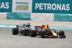 Max Verstappen, Red Bull Racing RB13, passes Lewis Hamilton, Mercedes AMG F1 W08 for the lead