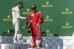 Lewis Hamilton, Mercedes-AMG F1 and Kimi Raikkonen, Ferrari celebrate on the podium with the champagne