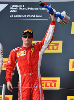 Kimi Raikkonen, Ferrari celebrates on the podium with the trophy