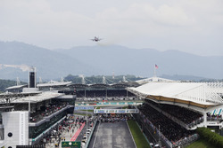 A jet flies over the pit straight ahead of the start