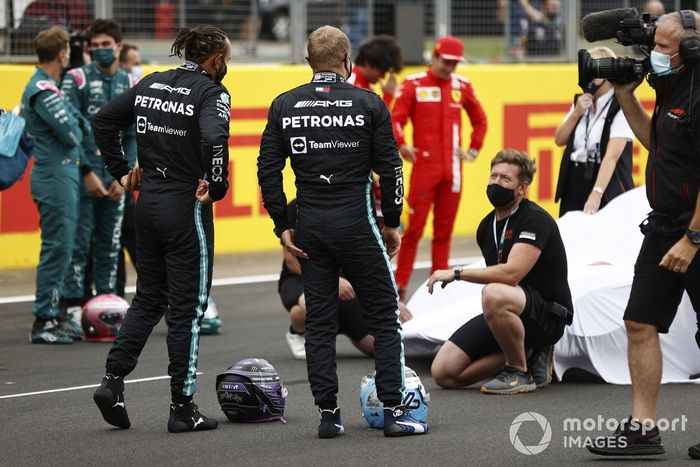 Sebastian Vettel, Aston Martin, Lance Stroll, Aston Martin, Lewis Hamilton, Mercedes, Valtteri Bottas, Mercedes, Carlos Sainz Jr., Ferrari, Charles Leclerc, Ferrari y un camarógrafo antes de la presentación del coche de Fórmula 1 de 2022