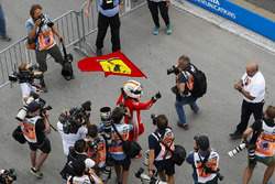 Sebastian Vettel, Ferrari, celebrates victory by waving a Prancing Horse flag