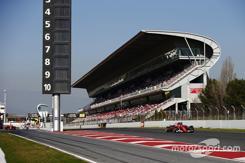 Kimi Raikkonen, Ferrari SF70H passes Carlos Sainz Jr., Scuderia Toro Rosso STR12, as Fernando Alonso