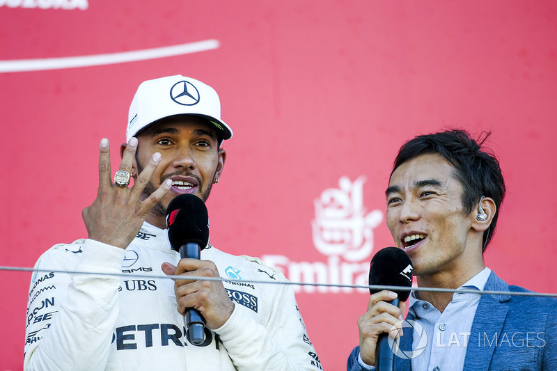 Race winner Lewis Hamilton, Mercedes AMG F1, tries on the Indy 500 winners ring belonging to interviewer Takuma Sato