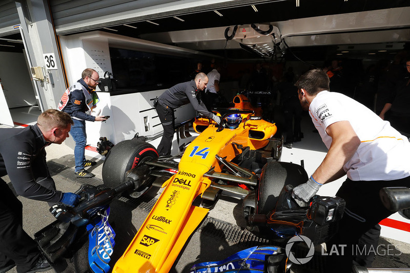 Fernando Alonso, McLaren MCL33, is returned to the garage