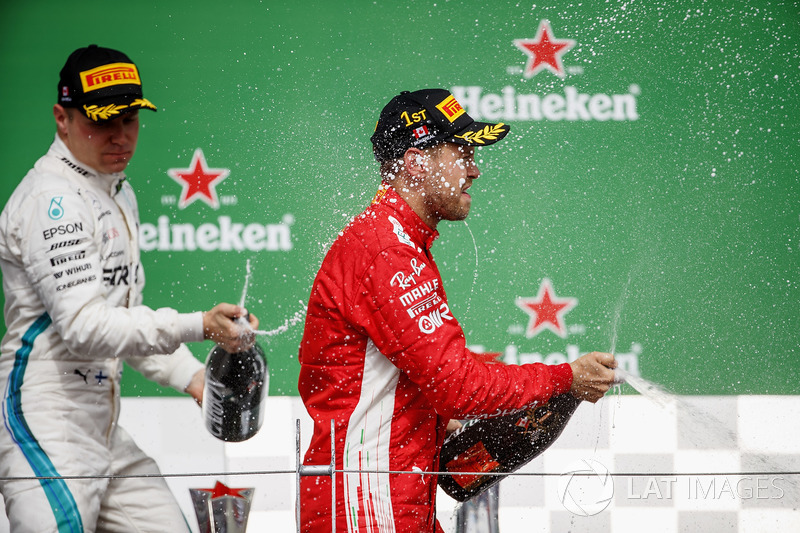 Valtteri Bottas, Mercedes AMG F1, 2nd position, and Sebastian Vettel, Ferrari, 1st position, celebra