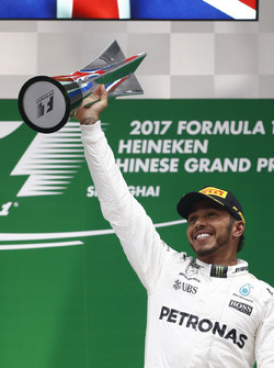 Lewis Hamilton, Mercedes AMG, celebrates with his trophy on the podium