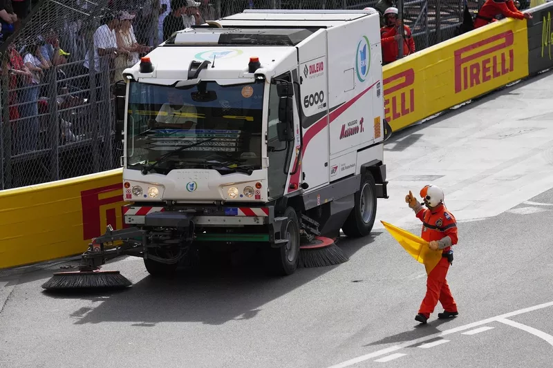The track is swept during a red flag delay.