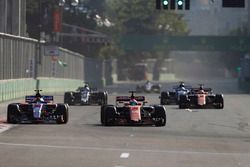 Fernando Alonso, McLaren MCL32, battles Daniil Kvyat, Scuderia Toro Rosso STR12, as behind Stoffel Vandoorne, McLaren MCL32 approaches some debris in his path