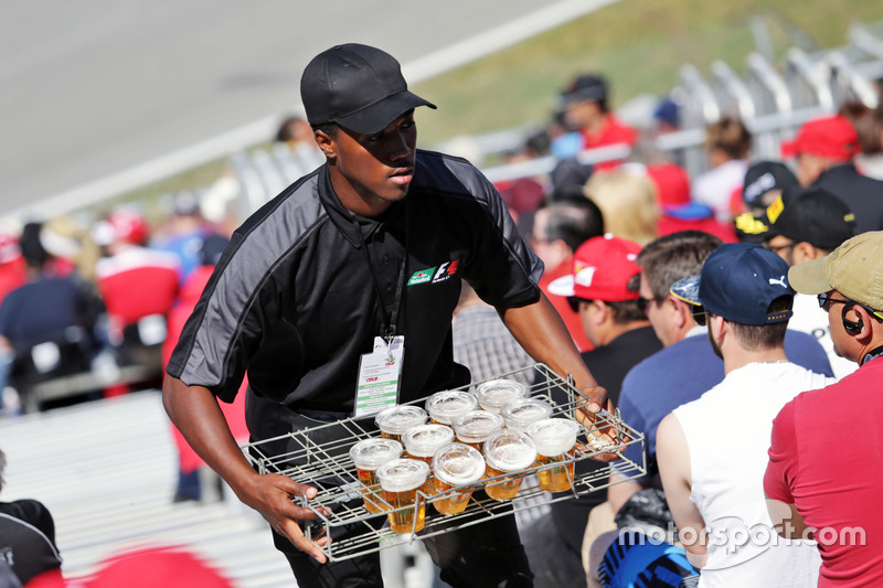 A drinks vendor in the grandstand