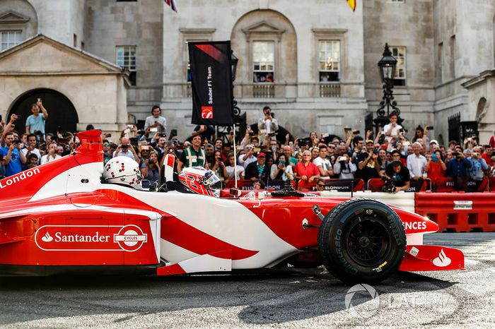 Jenson Button, McLaren, da un paseo de pasajero a Naomi Campbell en el coche de 2 plazas