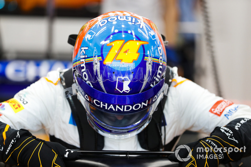 Fernando Alonso, McLaren, enters his cockpit