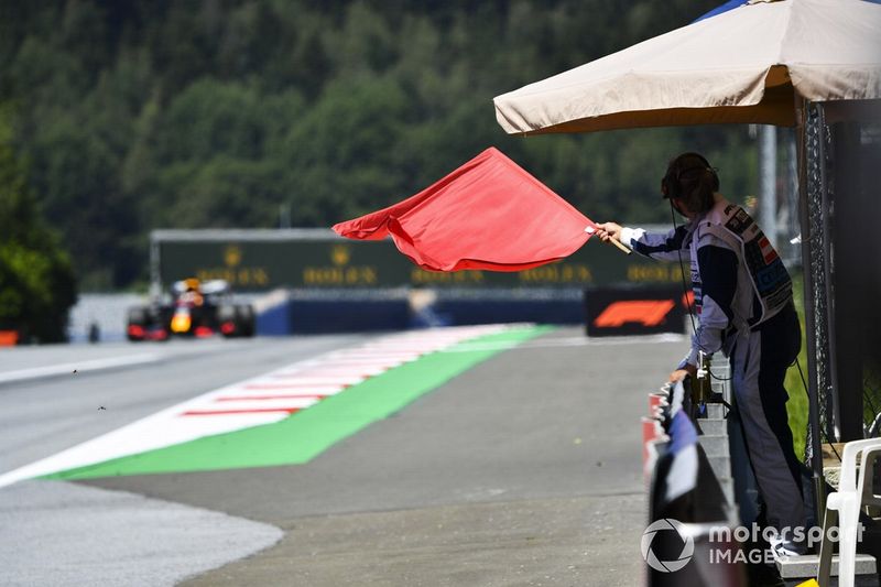 Un comisario con bandera roja al paso de Max Verstappen, Red Bull Racing RB16 