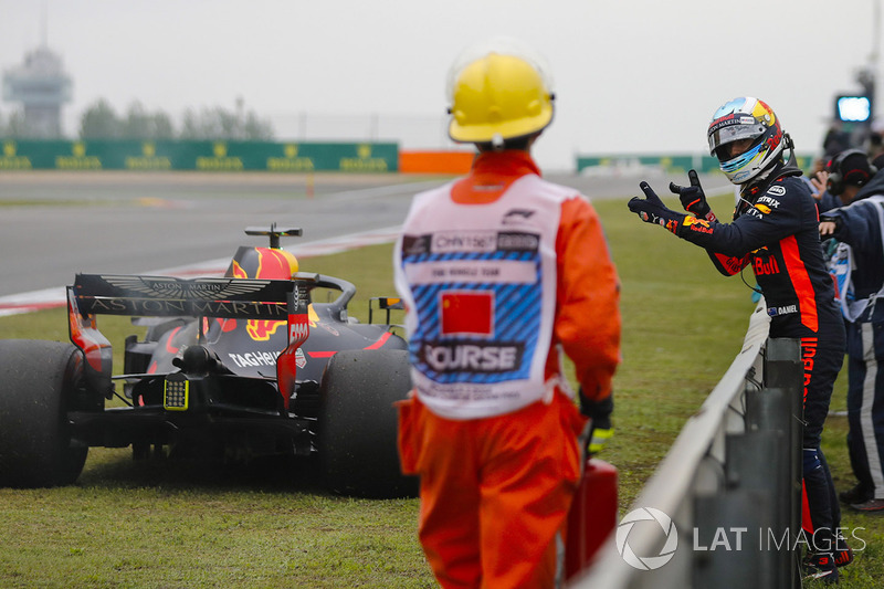 Daniel Ricciardo, Red Bull Racing, waits next to his stricken car