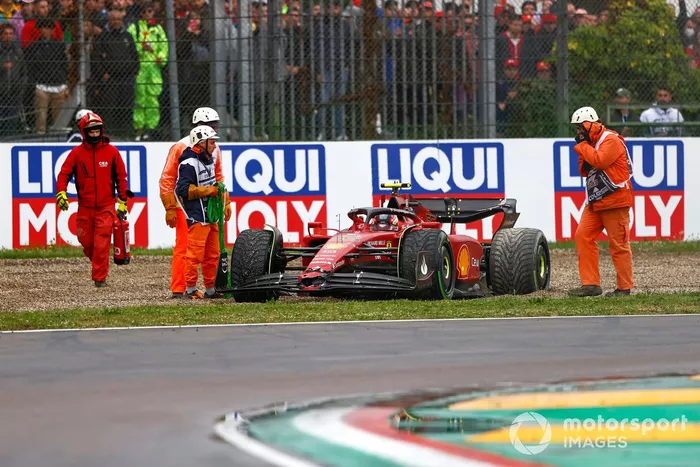 Los oficiales asisten a Carlos Sainz Jr., Ferrari F1-75, en la grava